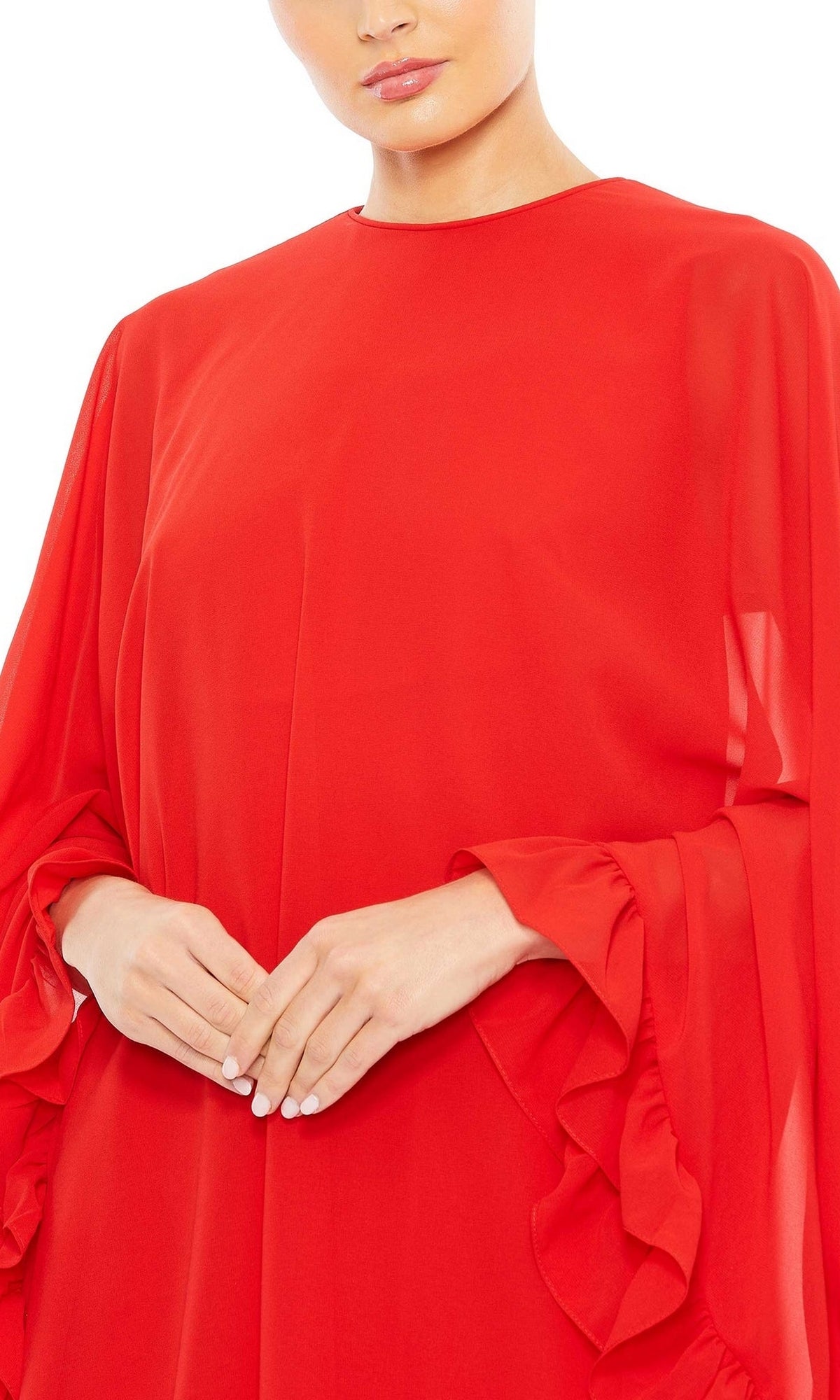 Someone wears the Mac Duggal Long Sleeve Short Red Dress 554071, featuring a high neck, ruffled long sleeves, and a loose fit in red, with hands gently clasped at the waist.